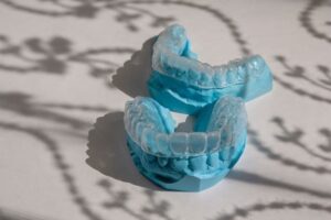 Invisalign® on top of blue dental casts